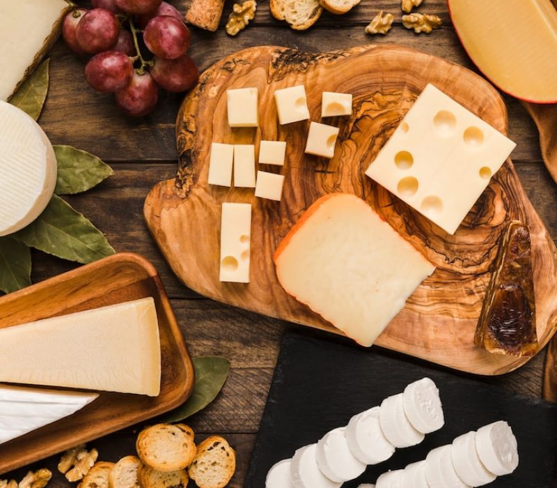 piece-natural-cheeses-cheese-board-with-tasty-ingredient-wooden-desk_23-2148101643