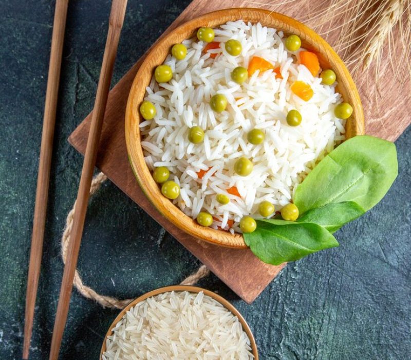 top-view-tasty-boiled-rice-with-green-beans-inside-plate-dark-desk_179666-27267